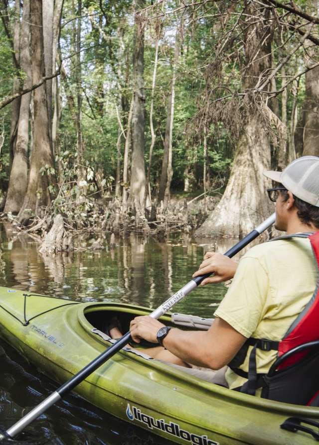 Man Kayaking on River