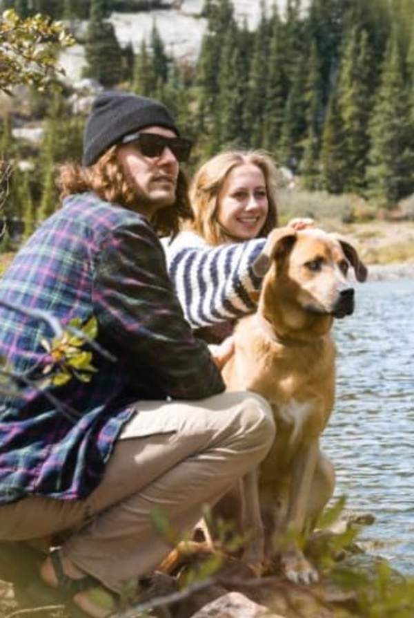 hikers and dog near water