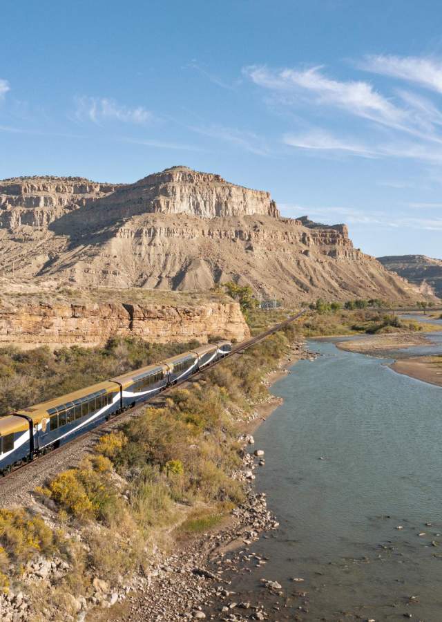 The Rocky Mountaineer trains passes by the Colorado River and some rocky outcroppings