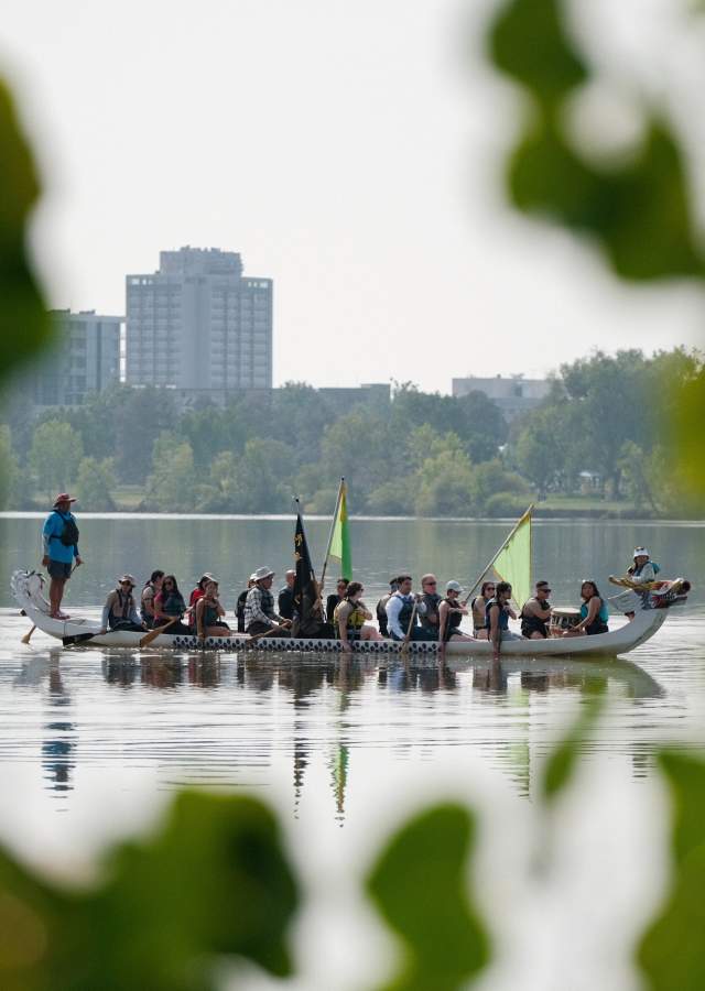 A crew paddles a dragon boat near the shore at Sloan's Lake during the Colorado Dragon Boat Festival.