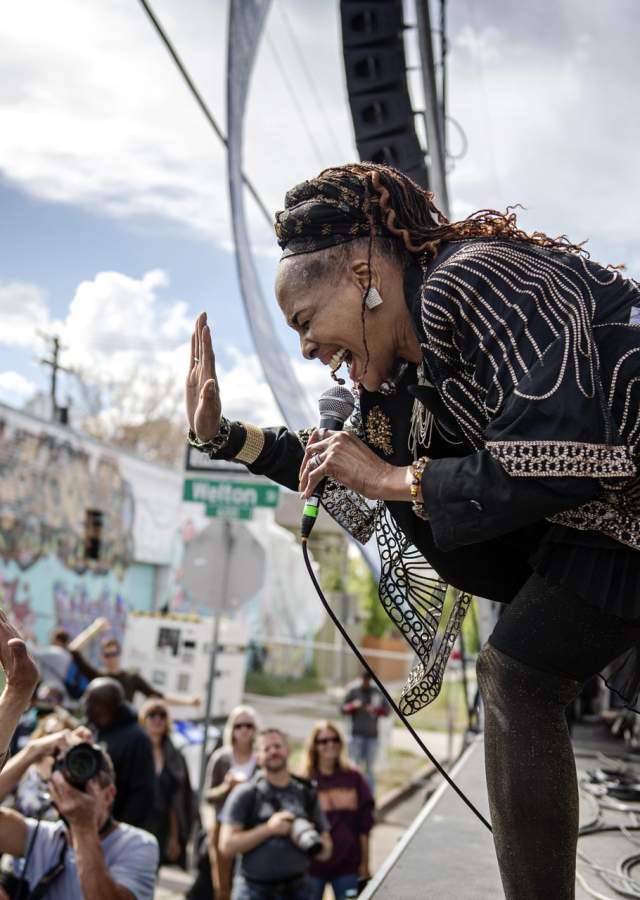 A singer performs passionately on stage in front of an audience