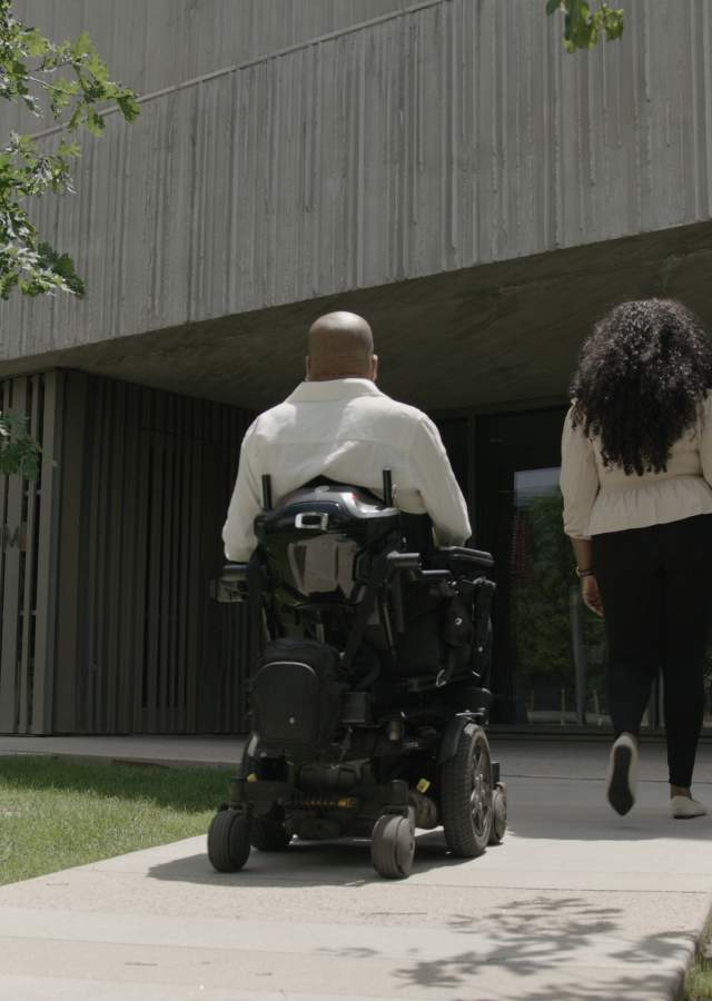 A person in a wheelchair and a companion enter Clyfford Still Museum in Denver, Colorado