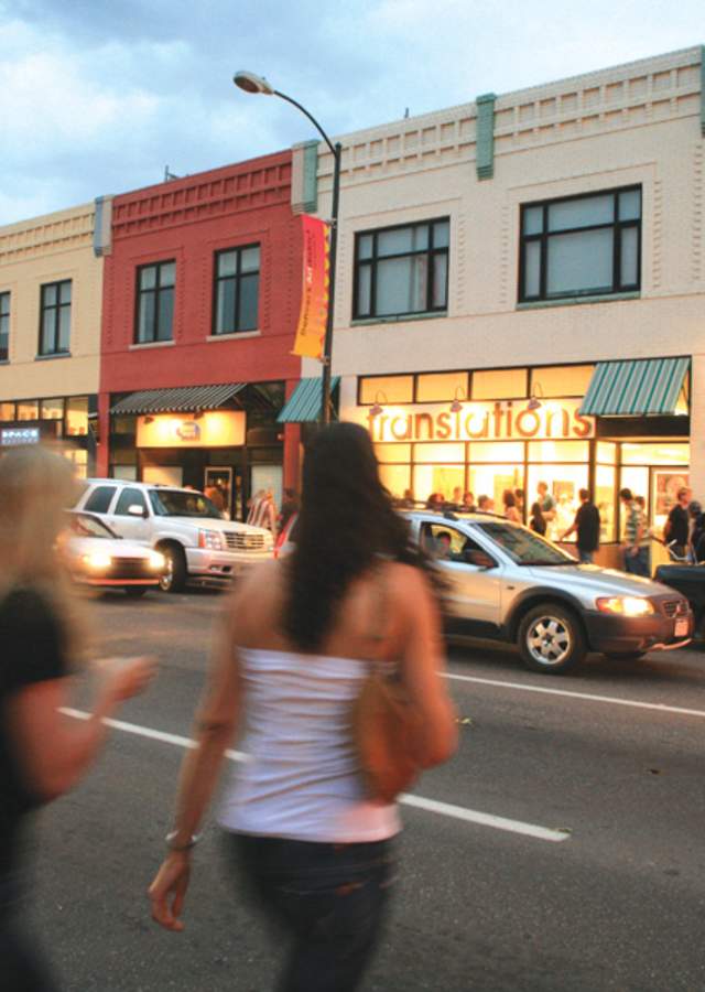 Two women crossing the street within the Art District on Santa Fe.