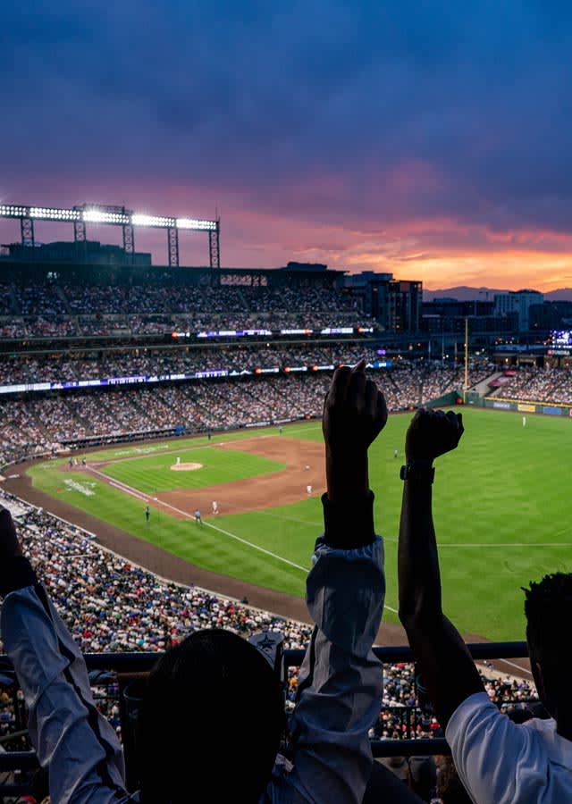 Fans at Coors Field during sunset