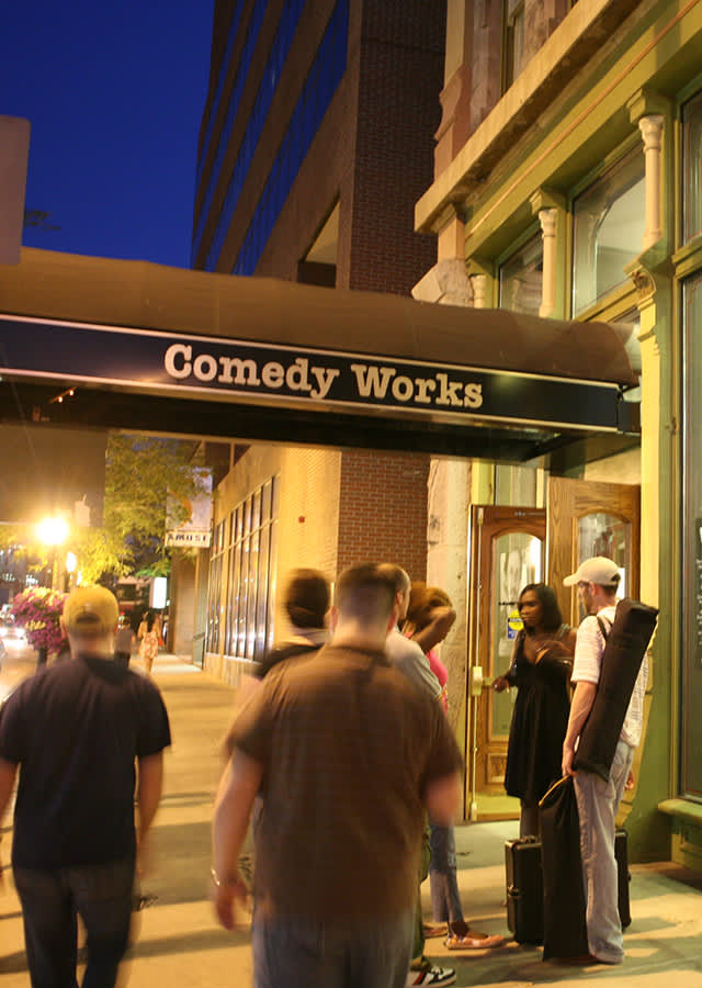 People standing outside Comedy Works in Denver, Colorado.
