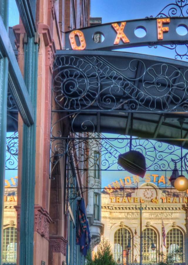 Exterior view of the Oxford Hotel with Denver Union Station in the background.