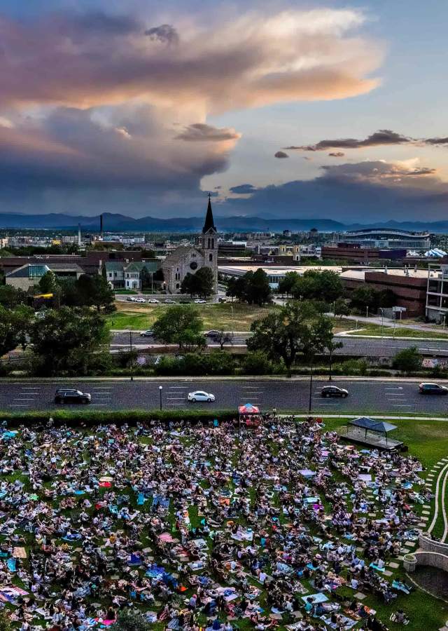 An aerial view of the Denver sculpture park at sunset during an outdoor movie screening
