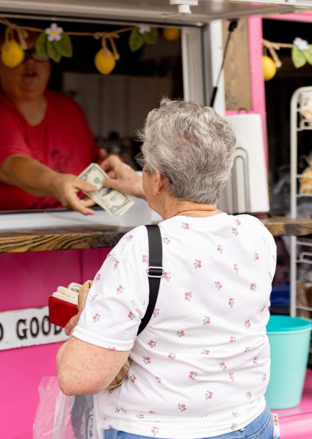 Pink food truck serving guests during a Denison community event