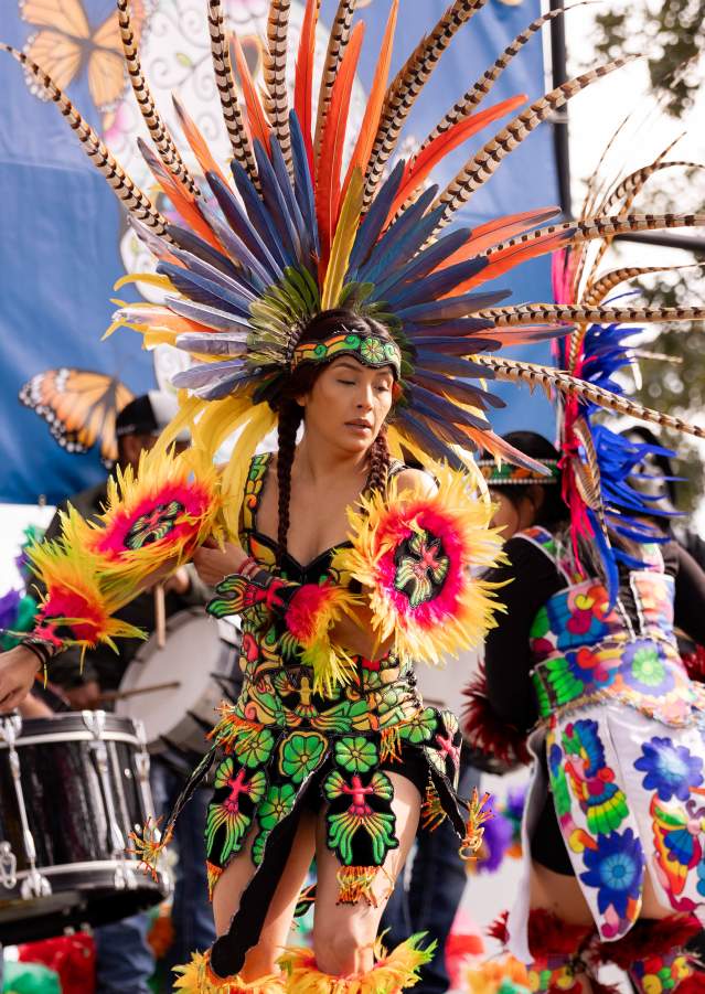 Performer in traditional attire dancing during Denison’s Dia de los Muertos celebration