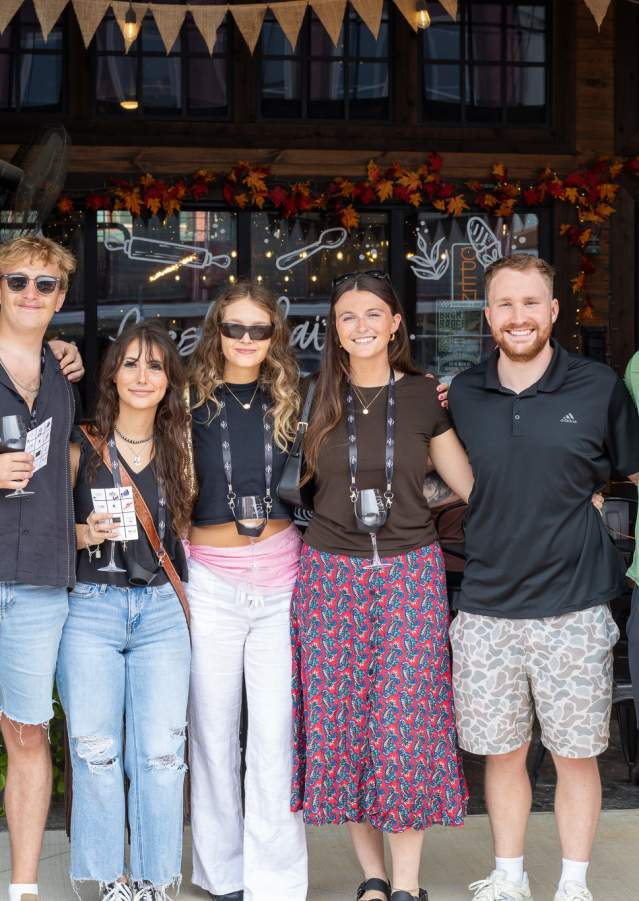 Friends posing together during a Downtown Denison Wine Walk event