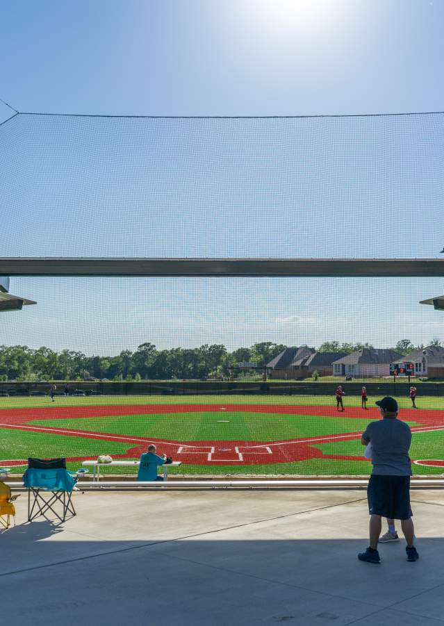 Players warming up prior to a softball game at Texoma Health Foundation Park