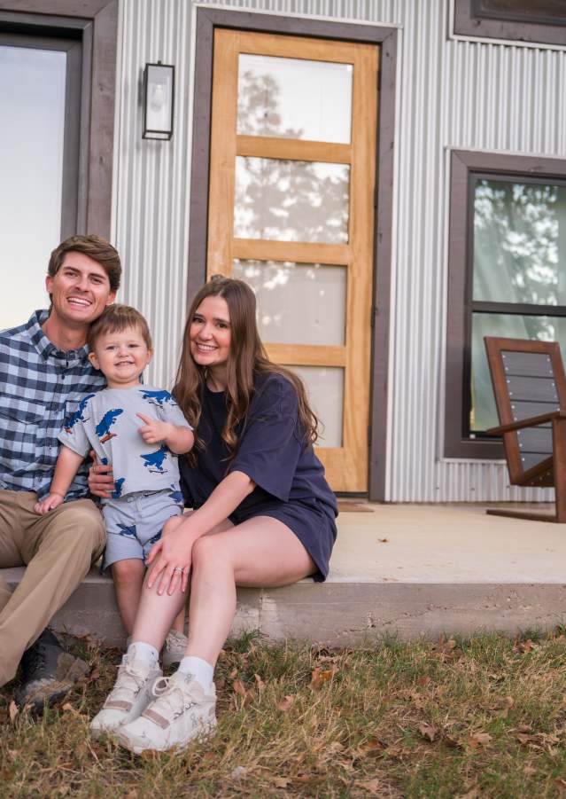 Family posing together on their cabin's front porch at Texas Tiny Cabins