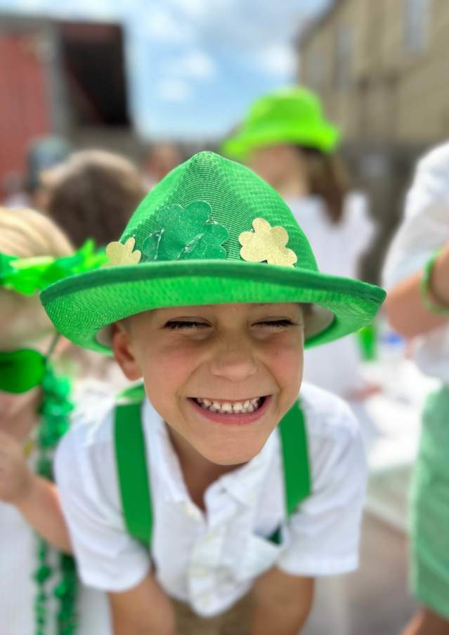 A child smiles for the camera at the Covington Celtic Club's annual St. Patrick's Day Parade.