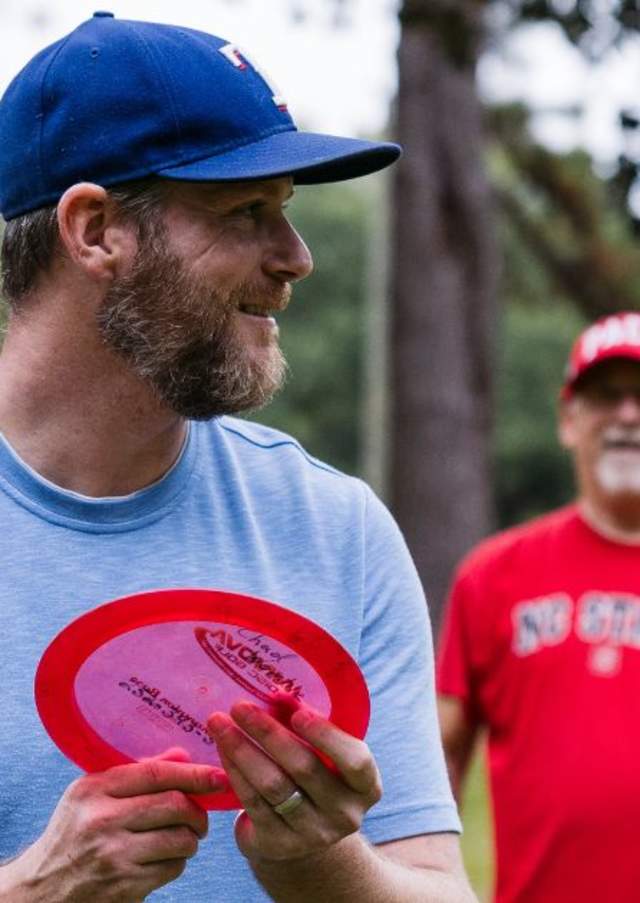 Two men playing disc golf in a park in Nash County, North Carolina