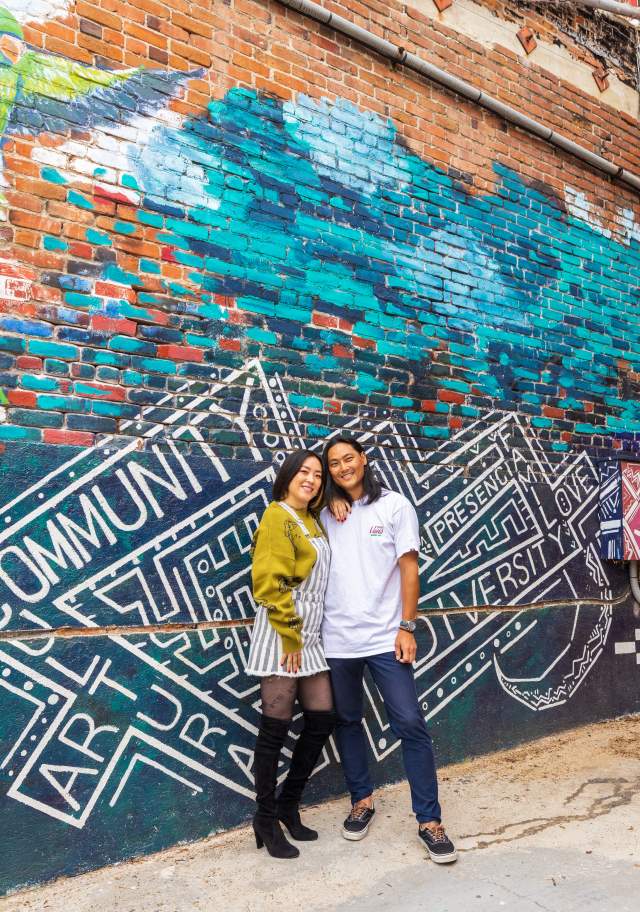Couple in front of mural