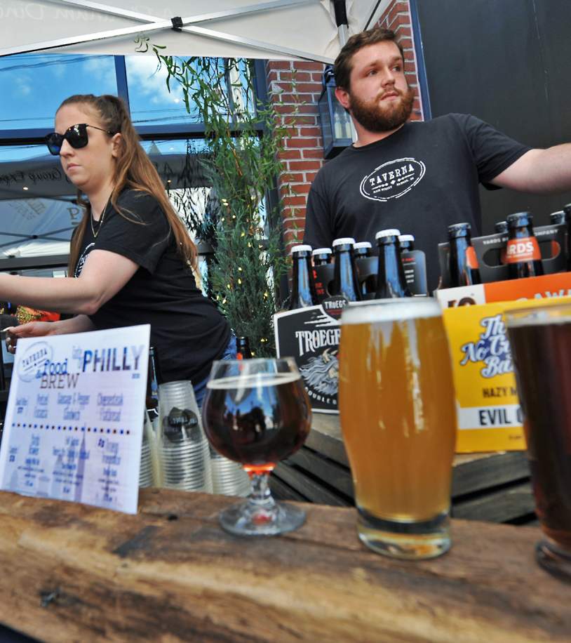 Bartenders serving beer at the Downtown Newark Food + Brew Festival