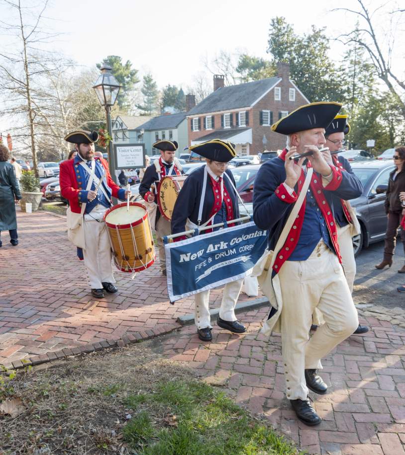 Colonial fife and drum corps in historical uniforms at Odessa holiday event