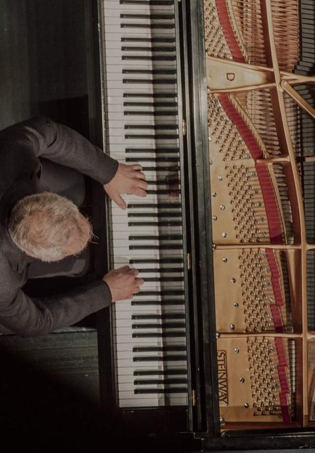 Man playing the piano from above