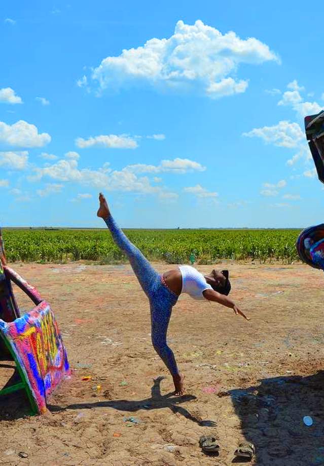 woman doing ballet pose at cadillac ranch in Amarillo, texas