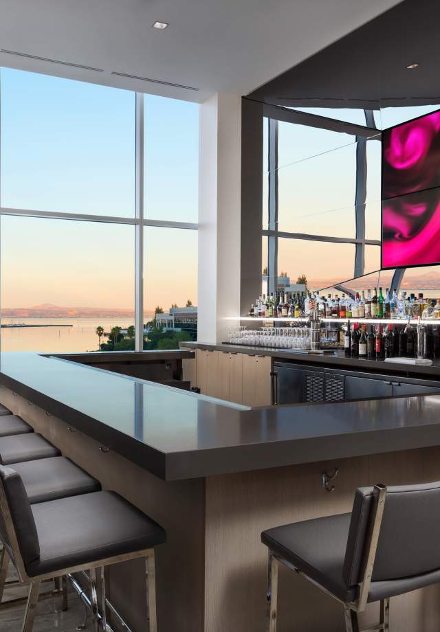 View of the bar lounge in the AC Hotel Airport Oyster Point Waterfront.