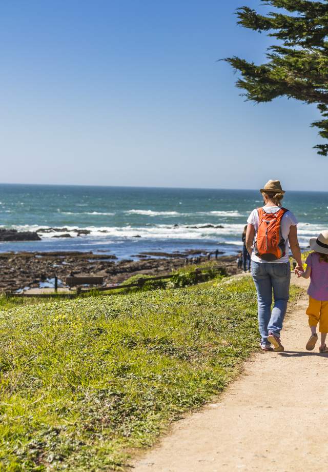 Family walking the trail at Fitzgerald Marine Reserve in San Mateo County.