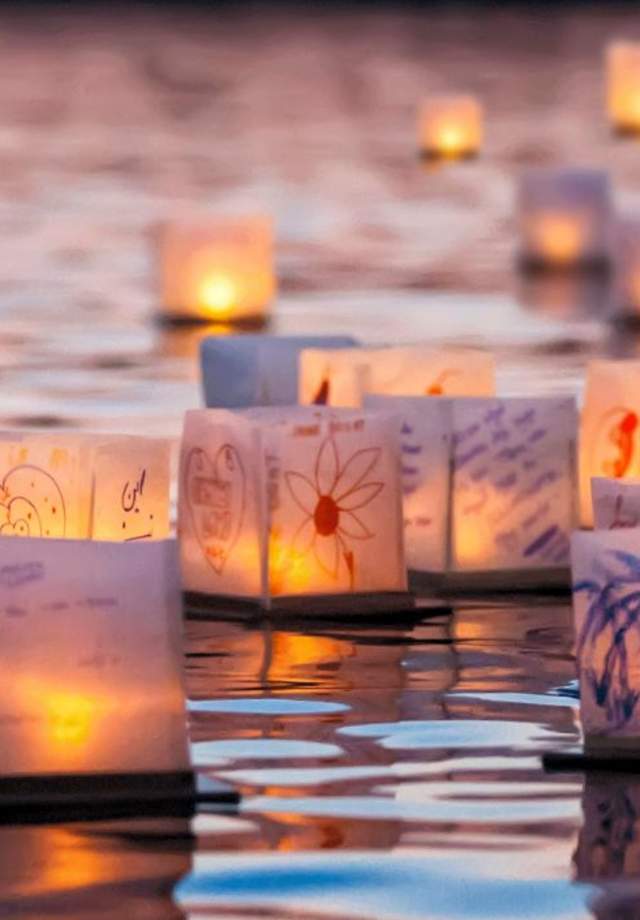 Lanterns on water at sunset
