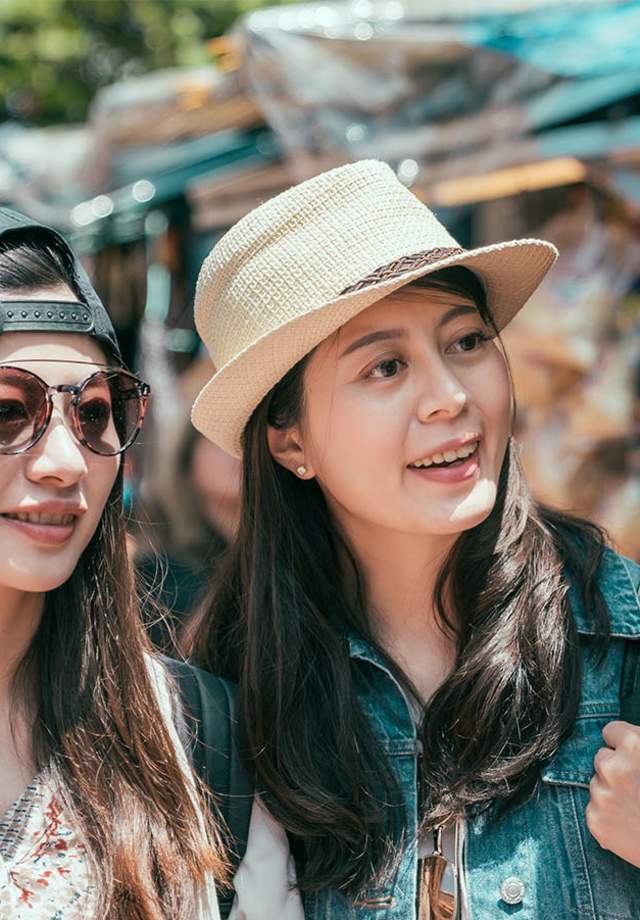Women browsing merchandise at booths at a fair