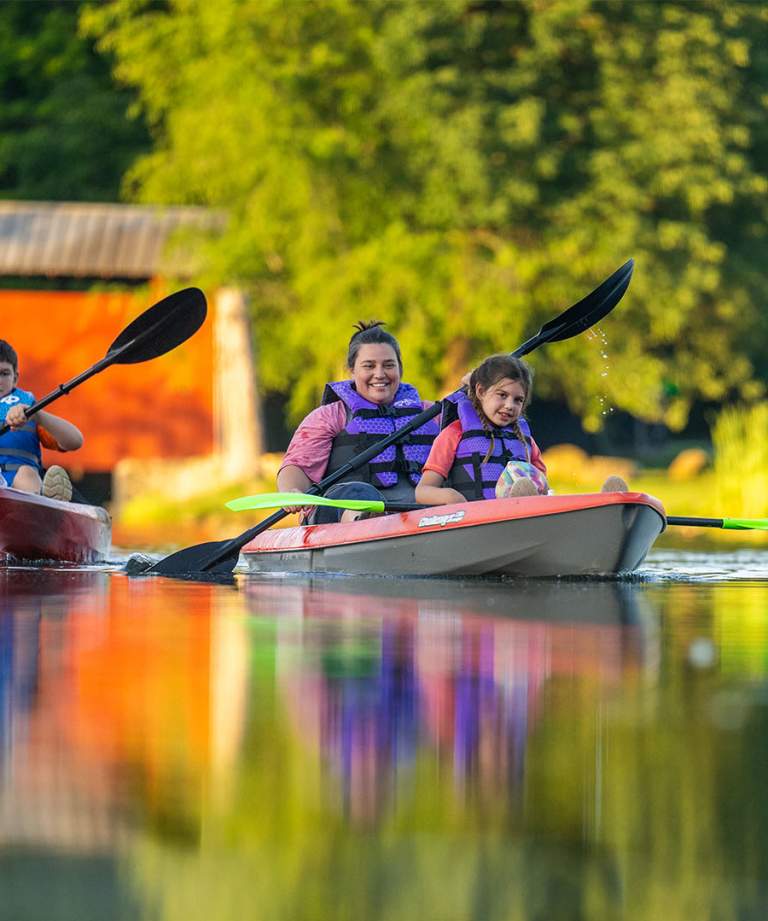 A family of 3 kayaking in Fowler Park, Terre Haute, Indiana