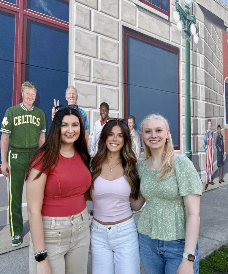 Young Women in front of Terminal mural