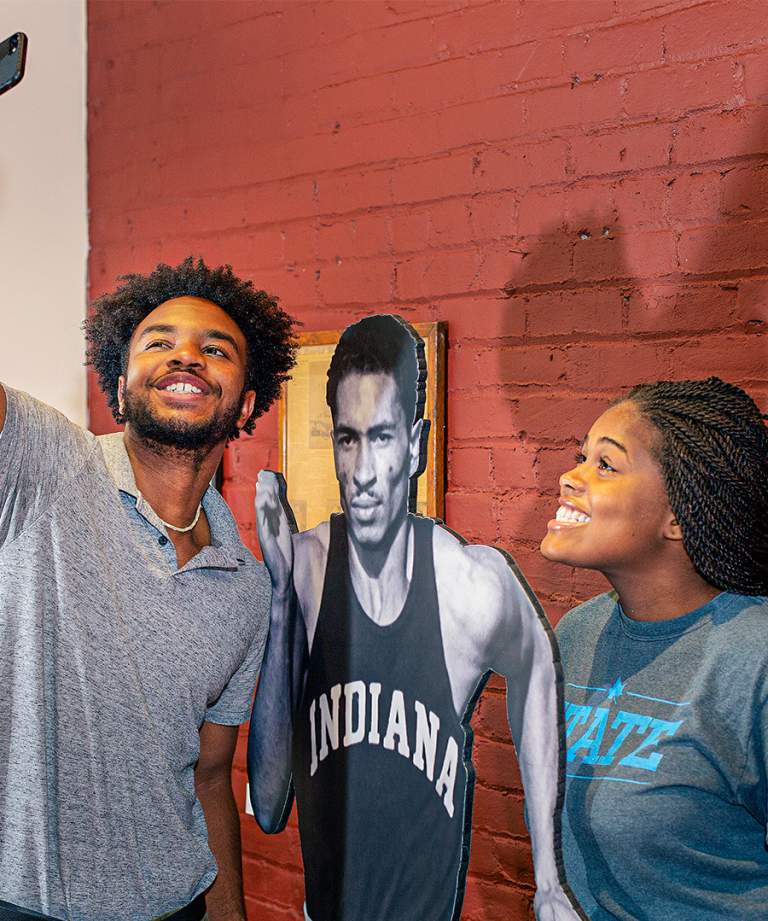 Two visitors taking a selfie at the Greg Bell exhibit at the Vigo County History Museum in Terre Haute, Indiana