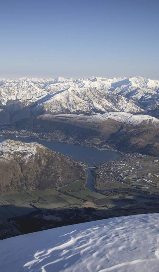 View from The Remarkables Lookout of dramatic snow-covered mountains and lake