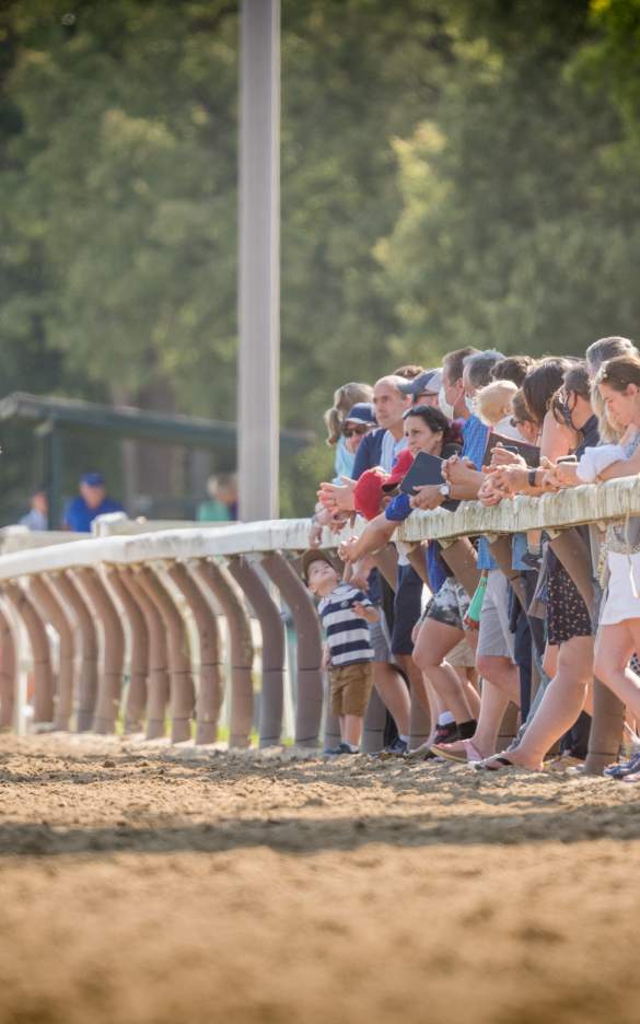 people standing on railing at Oklahoma Training Track