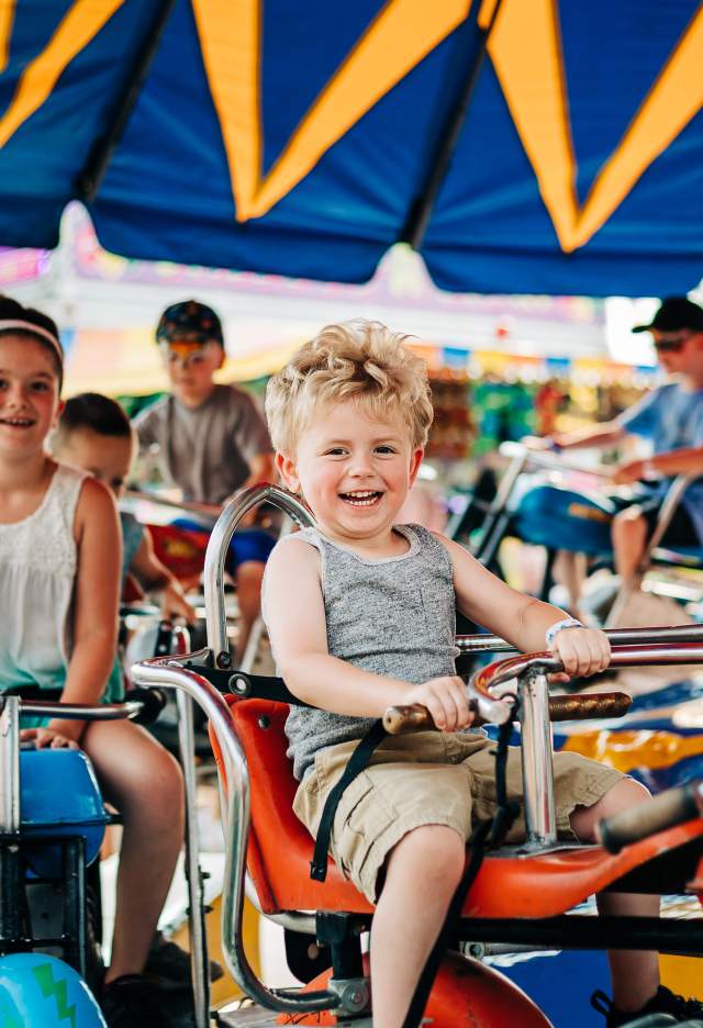 A child rides on a merry-go-round at the Allegany County Fair.