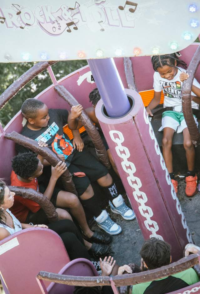 Kids riding one of the spinning rides at the Fun in the Park event for Juneteenth