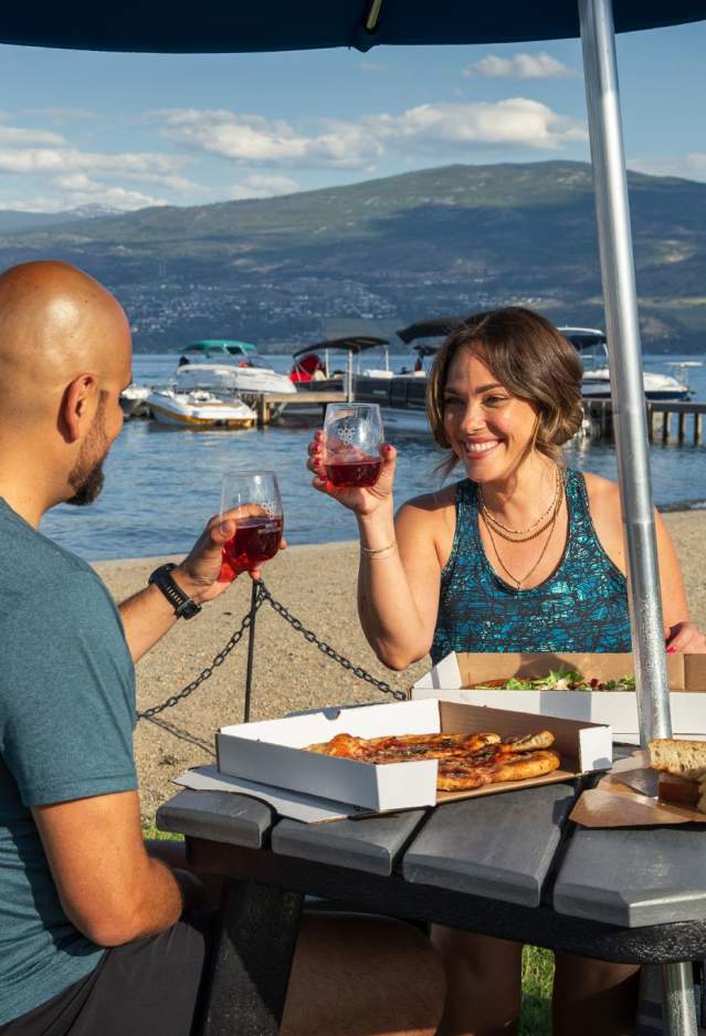 Couple with wine and food at Frind Winery picnic area