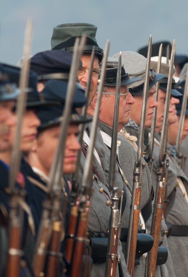 An image of men dressed as soldiers in a civil-war reenactment