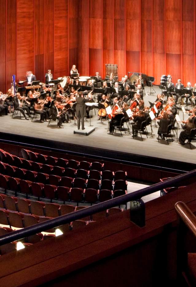 an orchestra on a stage in a theater
