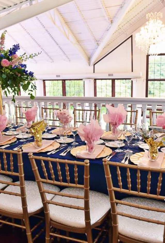 A long table with flowers and place settings