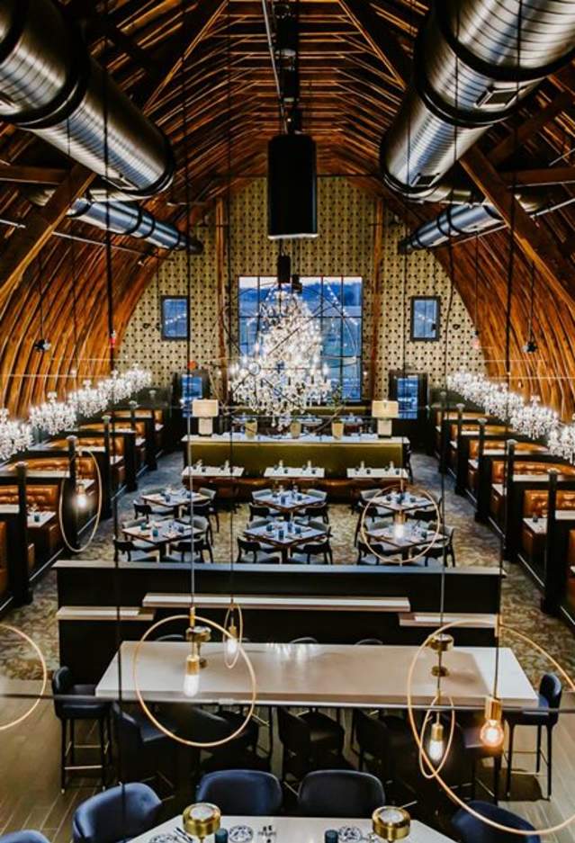Interior view of Black Sheep Restaurant with tables and chandeliers