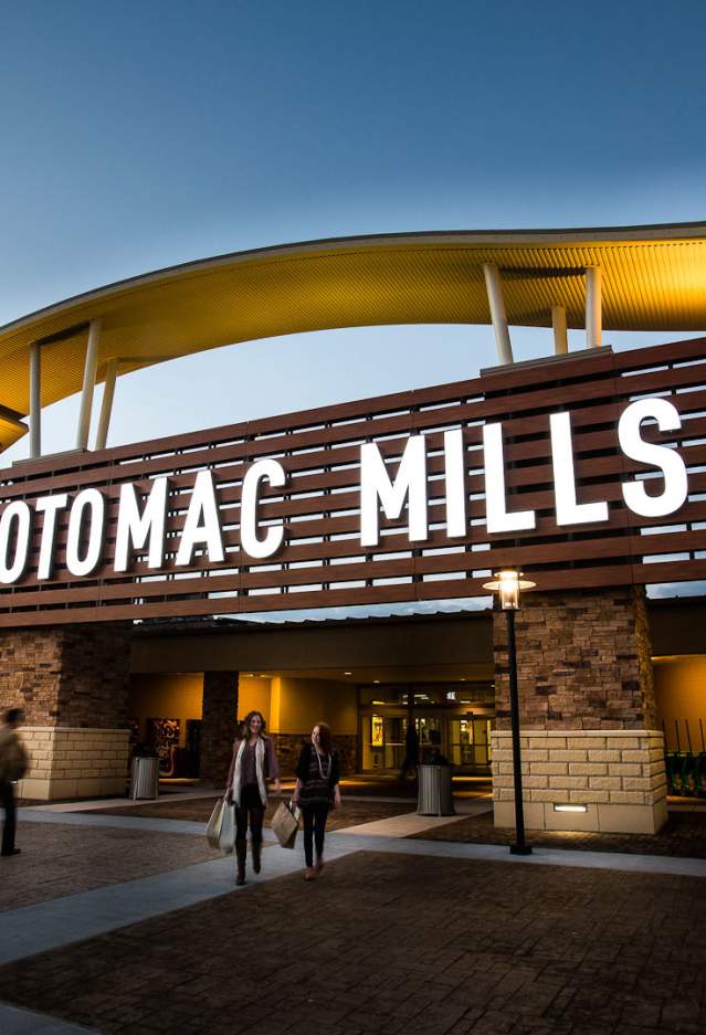 People walking into the "Potomac Mills" mall