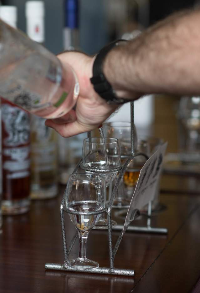 A bartender pouring drinks