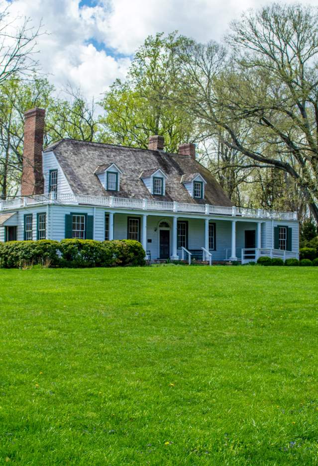 A white house with trees in the background