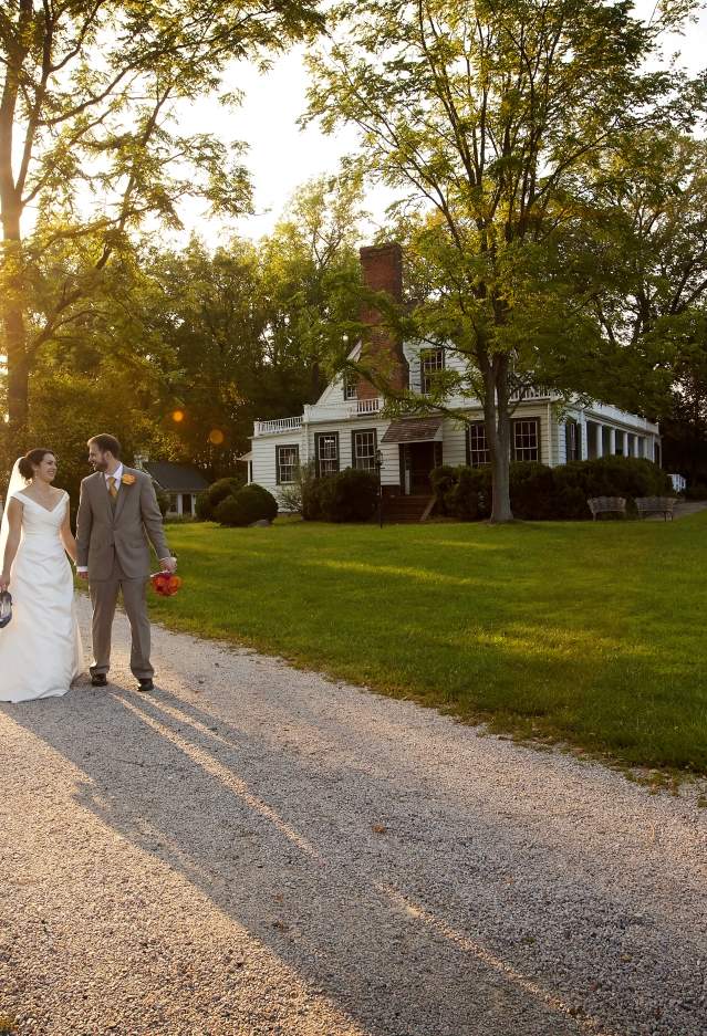 Bride and Groom walking along path in front of Rippon Lodge Historic Site