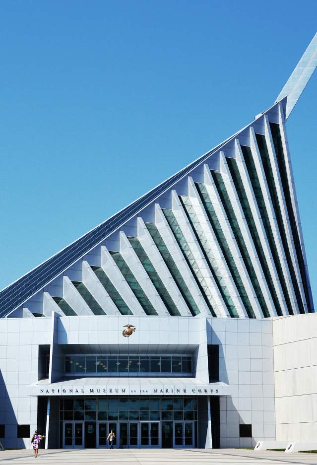 A white building with an off-center triangle roof