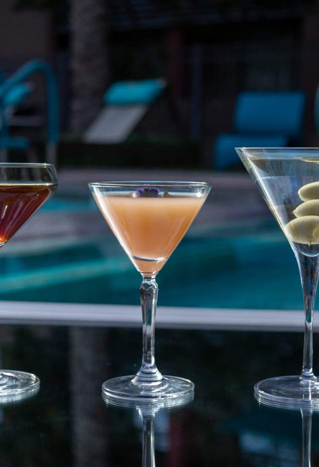 three cocktails by pool