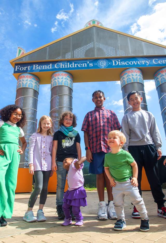 Kids in front of Fort Bend Children's Discovery Center facade