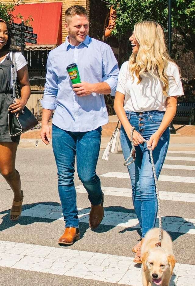 People walking in Downtown Edmond with puppy