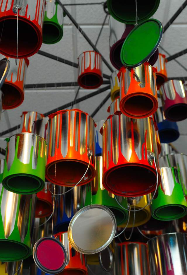 Art Installation with hanging paint cans of different bright colors
