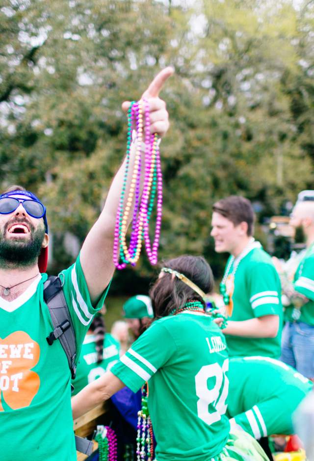 Man throwing beads at the annual Wearin' of the Green parade