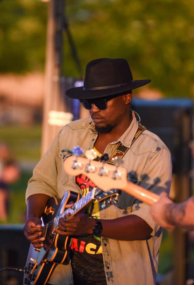 Musician playing guitar on outdoor stage